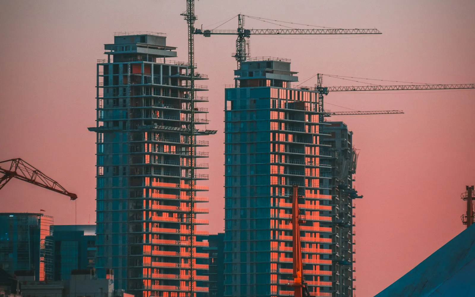 Construction crane over a building site at sunset