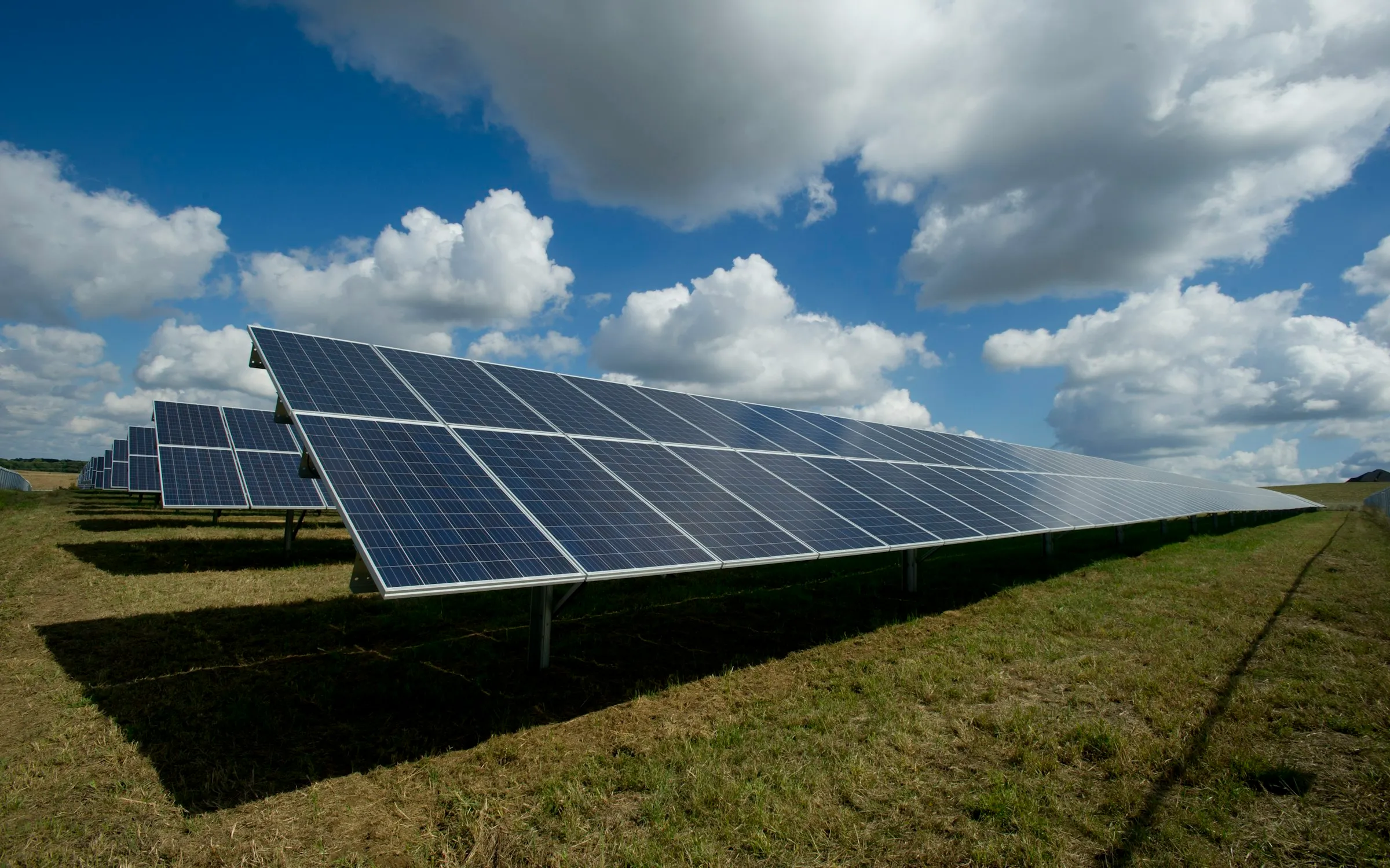 Solar panels generating off-grid power on an open site