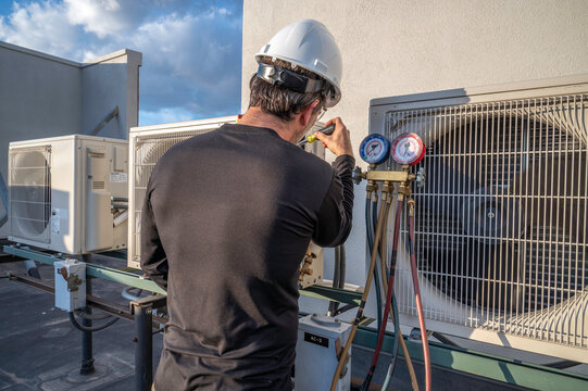 HVAC technician servicing an outdoor condenser unit