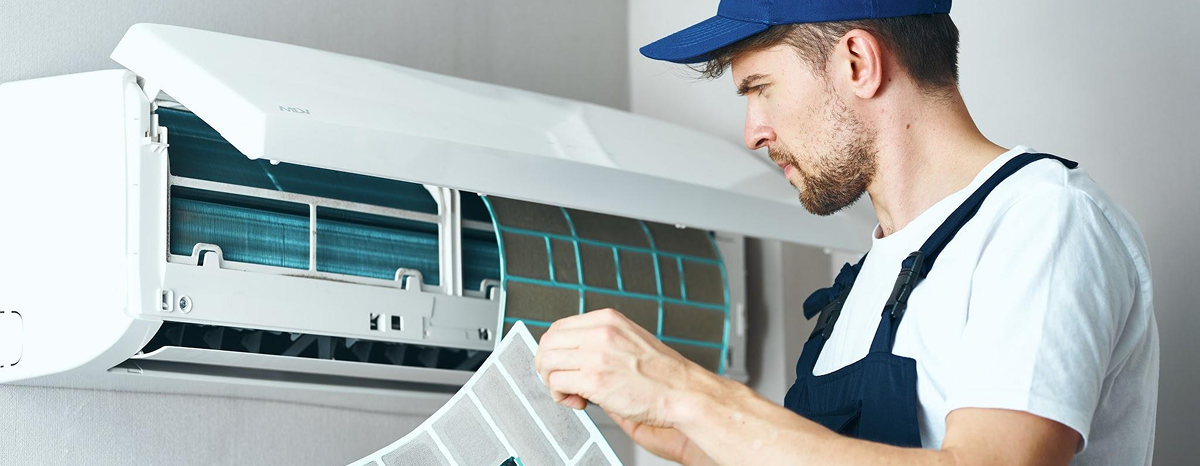 Technician checking outdoor AC condenser